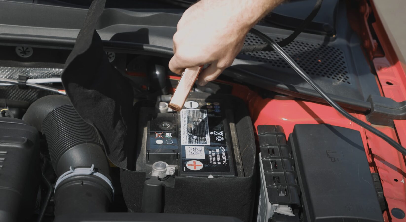 Professional Roadside Assistance - Battery Jump Start Service Roadside assistance technician jump starting car battery with professional equipment
